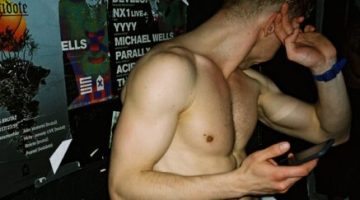 Shame and sex: A shirtless gay man covers his face in front of the camera, symbolising feelings of shame and intimacy.