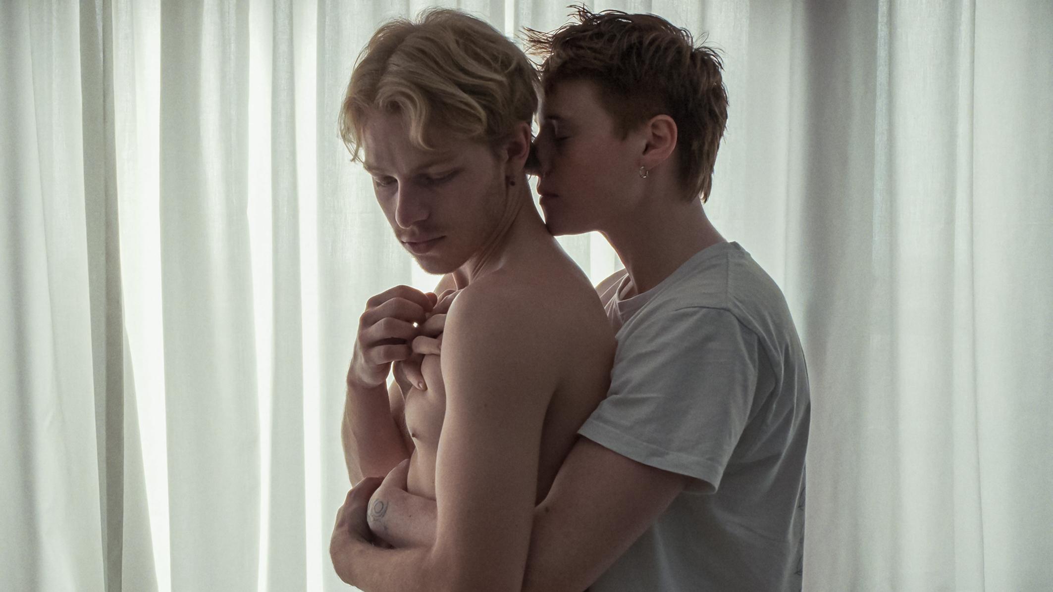 Intimate embrace between two men in a scene from the queer film „Sauna“ set in a gay sauna.